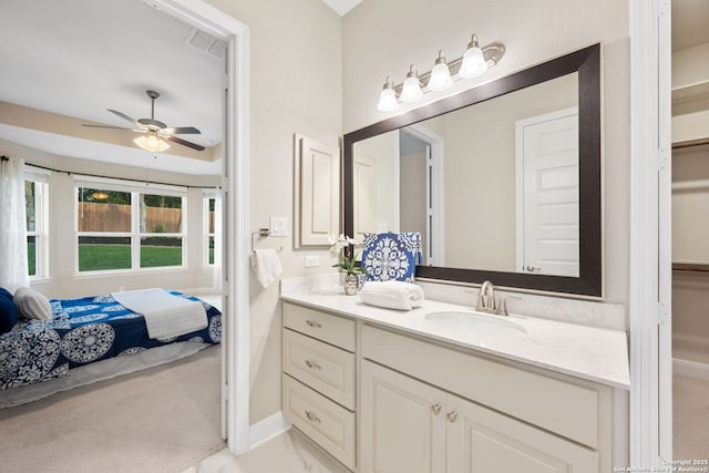 bathroom featuring vanity, connected bathroom, ceiling fan, and baseboards