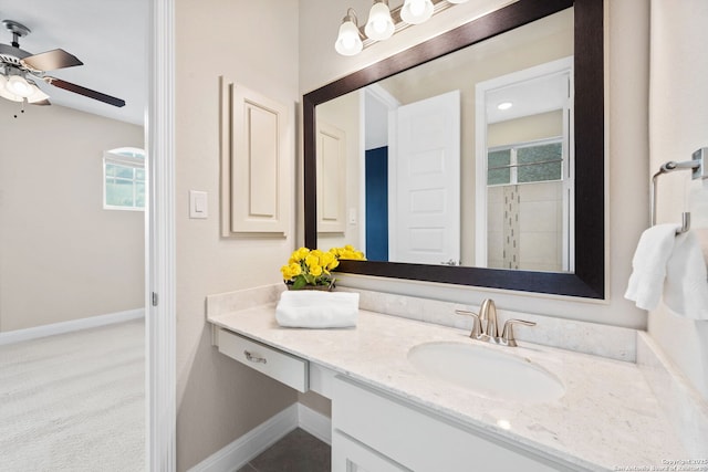 full bathroom with baseboards, ceiling fan, a wealth of natural light, and vanity
