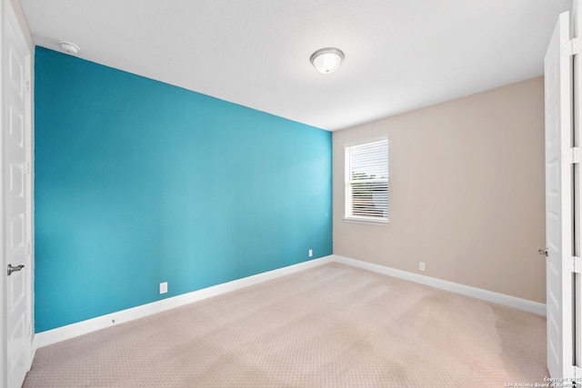 unfurnished bedroom with carpet floors and baseboards