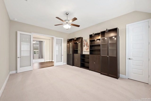 unfurnished bedroom featuring carpet flooring, baseboards, ceiling fan, and french doors