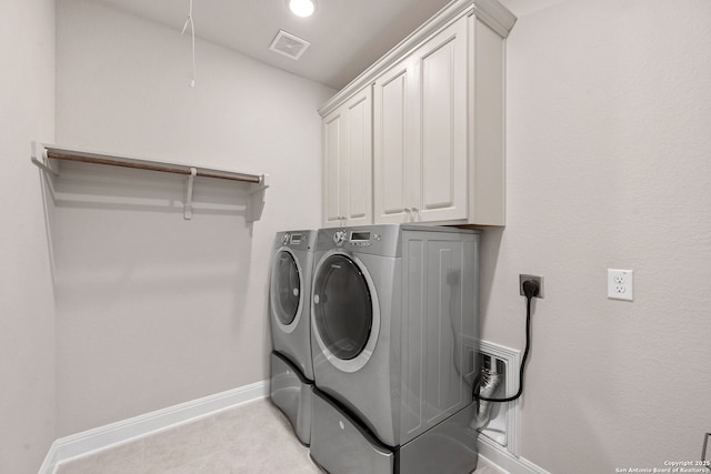 laundry area with attic access, visible vents, cabinet space, baseboards, and separate washer and dryer