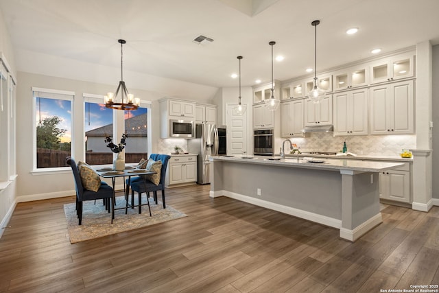 kitchen with stainless steel appliances, white cabinetry, recessed lighting, tasteful backsplash, and visible vents
