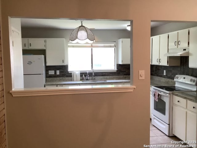 kitchen featuring a sink, decorative backsplash, under cabinet range hood, and white appliances
