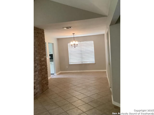 spare room featuring an inviting chandelier, baseboards, light tile patterned flooring, and visible vents