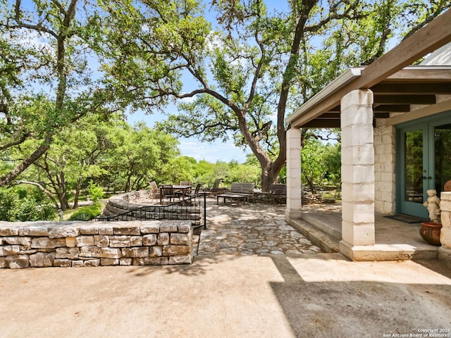 view of yard featuring a patio, french doors, and outdoor dining area
