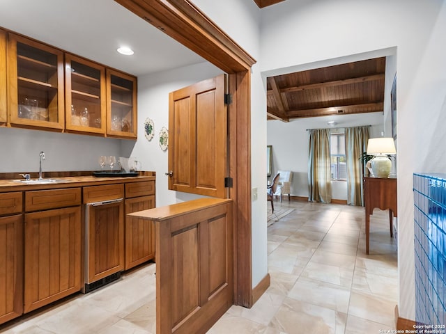 bar with beam ceiling, a sink, indoor wet bar, recessed lighting, and wood ceiling