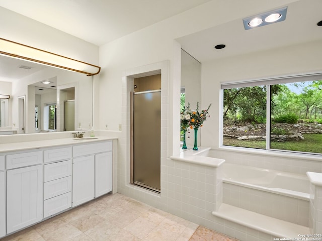 bathroom with vanity, a stall shower, tile patterned floors, and a bath