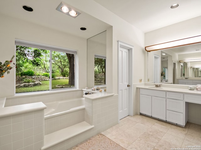 full bathroom featuring recessed lighting, vanity, tile patterned floors, and a bath