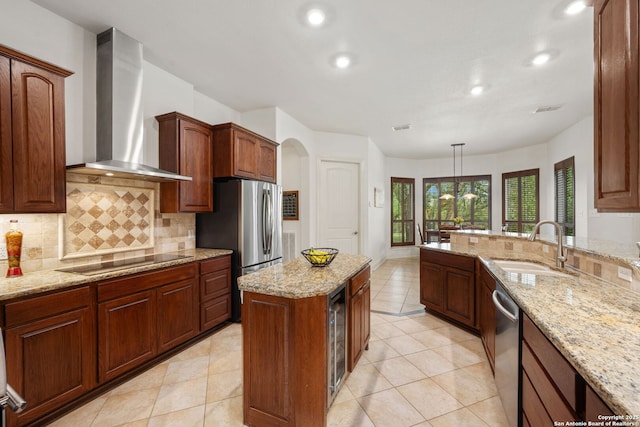 30406 Saddleridge, Bulverde, TX 78163 - kitchen featuring wall chimney range hood, tasteful backsplash, light stone countertops, a sink, and stainless steel appliances