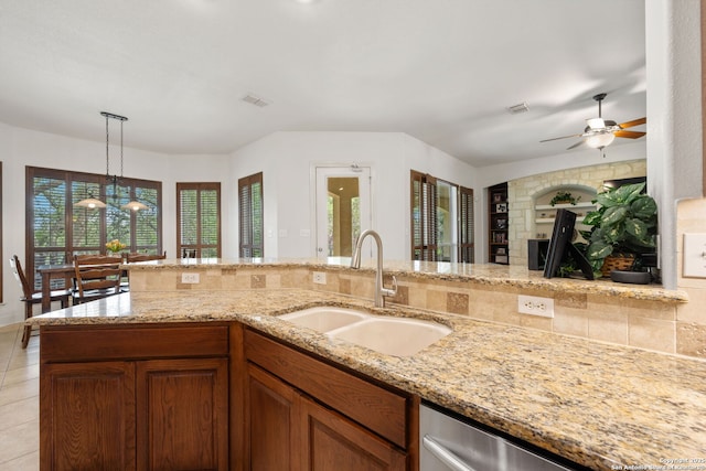 30406 Saddleridge, Bulverde, TX 78163 - kitchen featuring decorative light fixtures, a fireplace, a sink, light stone counters, and ceiling fan with notable chandelier
