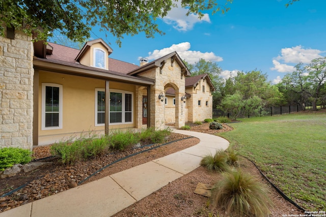 30406 Saddleridge, Bulverde, TX 78163 - view of front of property featuring stone siding, fence, a front yard, and stucco siding