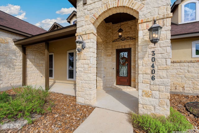 30406 Saddleridge, Bulverde, TX 78163 - view of exterior entry with roof with shingles and stone siding