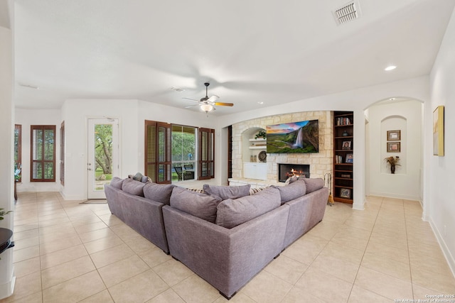 30406 Saddleridge, Bulverde, TX 78163 - living room with ceiling fan, a fireplace, built in shelves, light tile patterned floors, and baseboards
