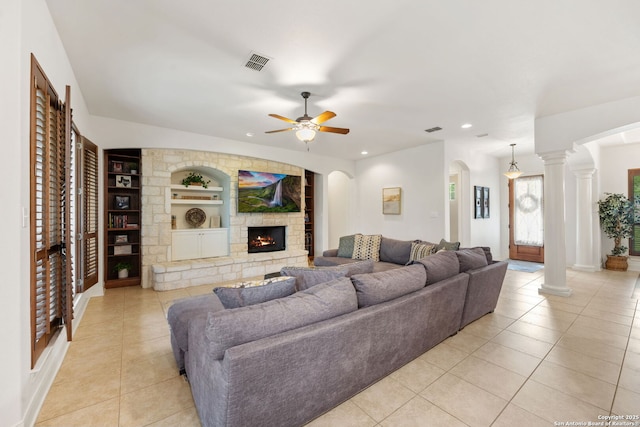 30406 Saddleridge, Bulverde, TX 78163 - living room featuring decorative columns, visible vents, built in features, a fireplace, and light tile patterned flooring