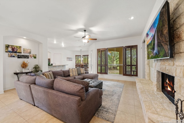 30406 Saddleridge, Bulverde, TX 78163 - living room with light tile patterned flooring, a stone fireplace, baseboards, ceiling fan, and recessed lighting