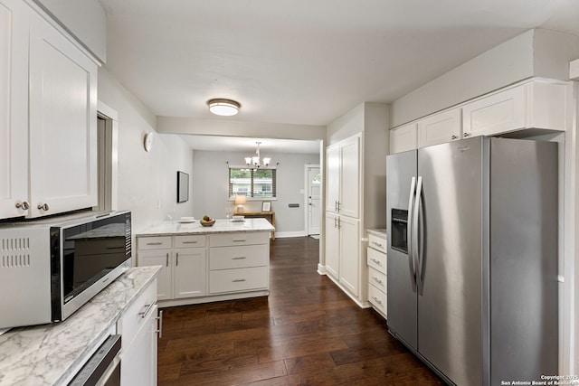 kitchen featuring dark wood finished floors, white cabinets, appliances with stainless steel finishes, and a chandelier