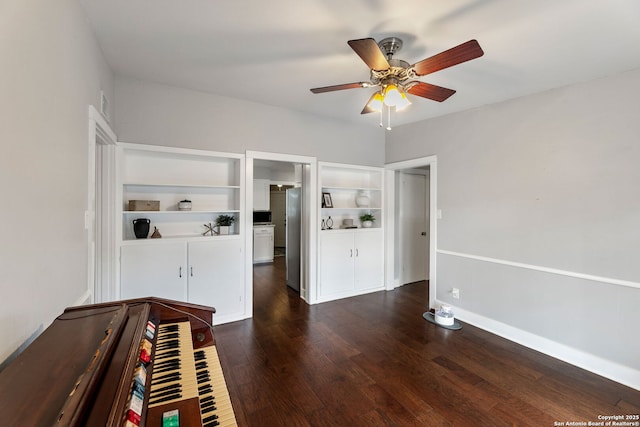 unfurnished bedroom with baseboards, dark wood finished floors, and ceiling fan