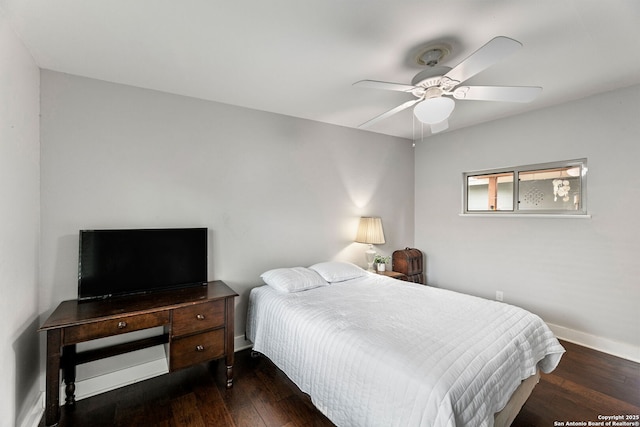 bedroom featuring baseboards, dark wood-style floors, and ceiling fan