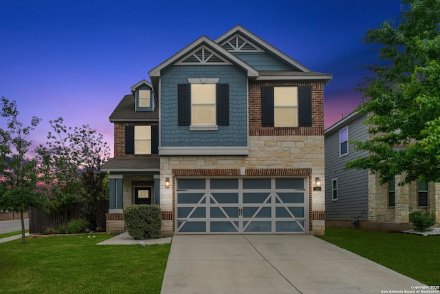 craftsman-style home with a front lawn, stone siding, a garage, brick siding, and driveway