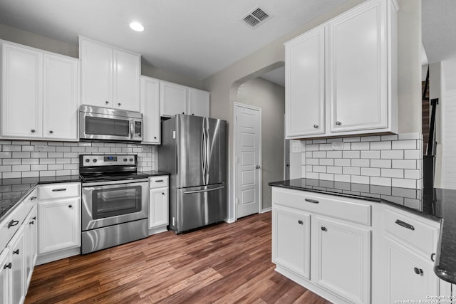 kitchen with visible vents, white cabinetry, dark wood-style floors, and stainless steel appliances