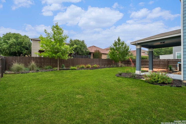 view of yard with a fenced backyard