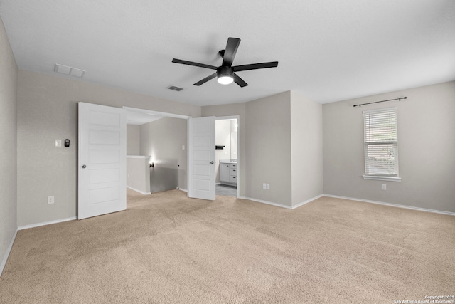 unfurnished bedroom featuring baseboards, visible vents, and light carpet