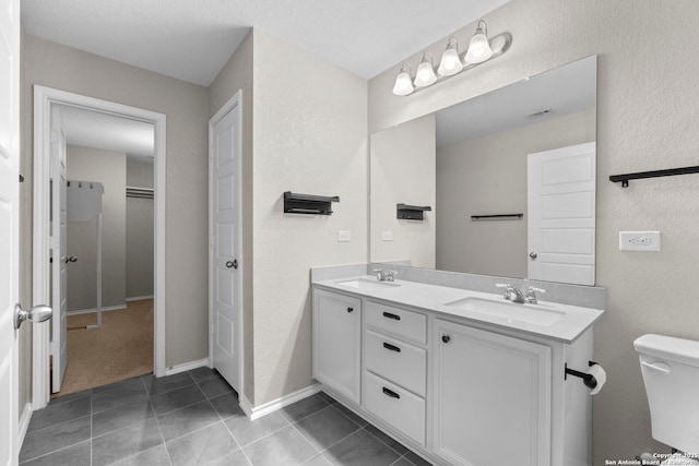 bathroom featuring a sink, toilet, double vanity, and visible vents