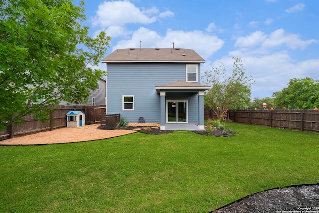 rear view of property with a yard, a patio, and a fenced backyard