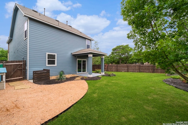back of property with a fenced backyard, a gate, a lawn, and a patio area