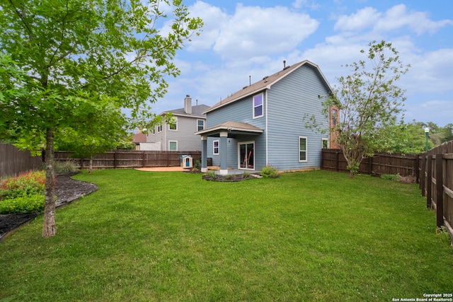 back of property with a lawn, a patio, and a fenced backyard