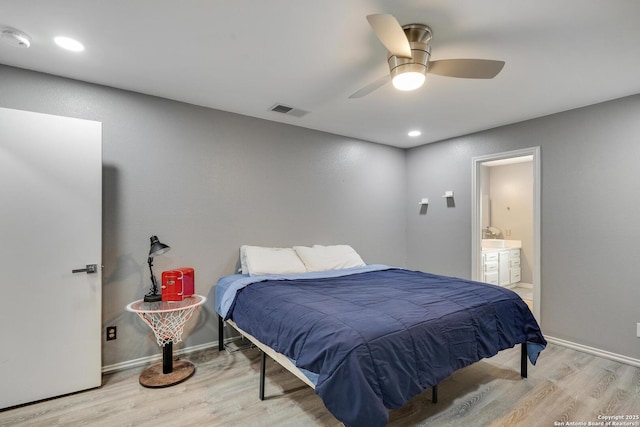 bedroom featuring visible vents, a ceiling fan, connected bathroom, and wood finished floors