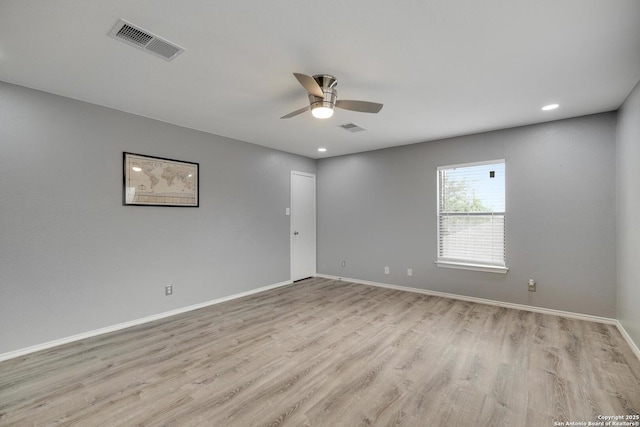 unfurnished room featuring visible vents, a ceiling fan, baseboards, and light wood finished floors