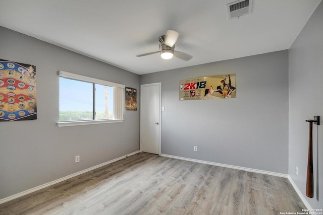 empty room with a ceiling fan, baseboards, visible vents, and light wood-type flooring