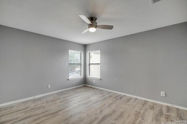 empty room with light wood-type flooring, baseboards, and ceiling fan