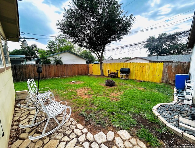 122 Hartford Ave, San Antonio, TX 78223 - view of yard with a fenced backyard and an outdoor fire pit