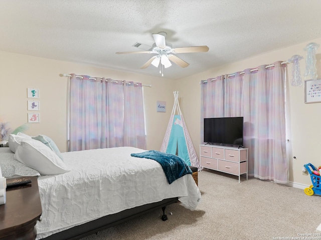bedroom with carpet floors, a ceiling fan, and a textured ceiling