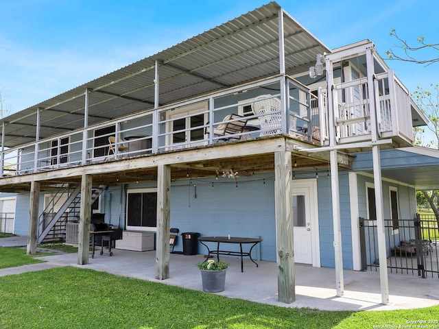 186 Trout, Palacios, TX 77465 - rear view of house with stairs, a patio area, and a deck