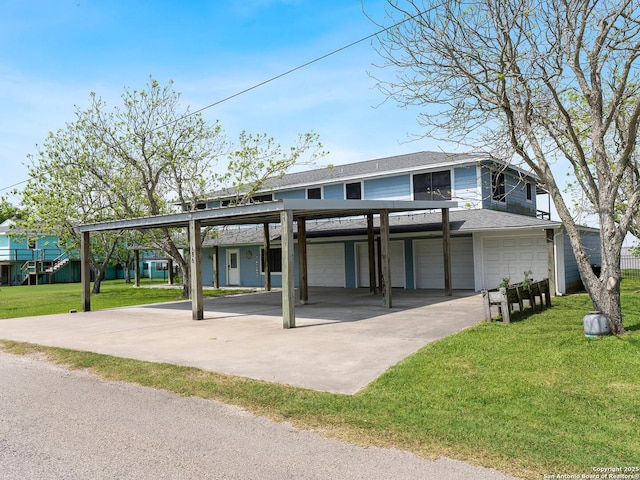 186 Trout, Palacios, TX 77465 - view of front facade featuring a shingled roof, an attached garage, a front lawn, a carport, and driveway