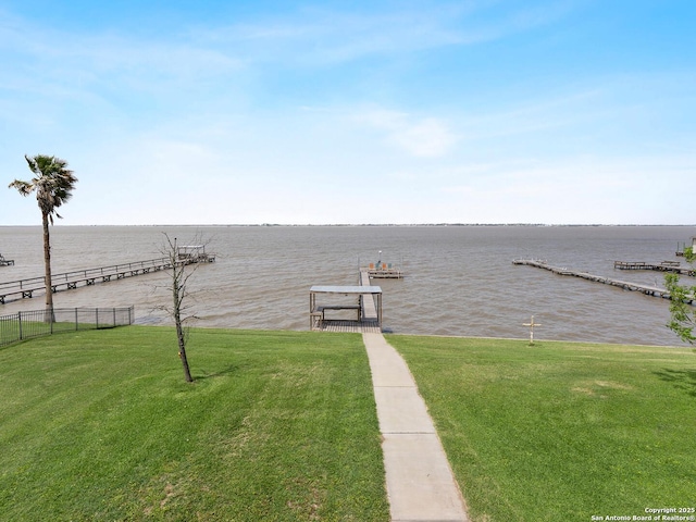 exterior space featuring a water view and fence