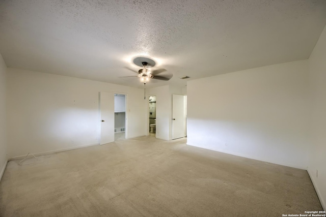 interior space featuring visible vents, light carpet, ceiling fan, a textured ceiling, and a spacious closet