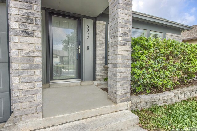 property entrance with brick siding