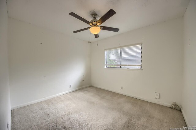 unfurnished room featuring baseboards, a ceiling fan, and light colored carpet