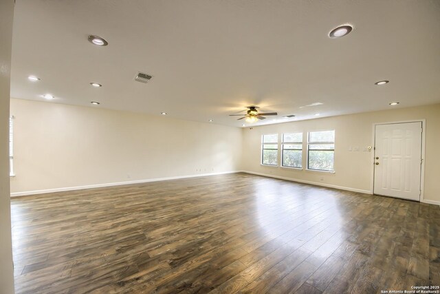 spare room featuring ceiling fan, visible vents, baseboards, dark wood-style floors, and recessed lighting