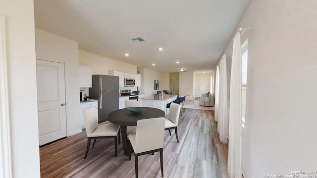 dining area featuring visible vents, recessed lighting, and light wood-type flooring
