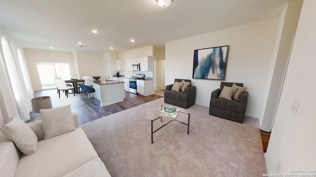 living room featuring recessed lighting and dark wood finished floors
