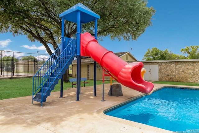 community playground featuring a fenced in pool and fence