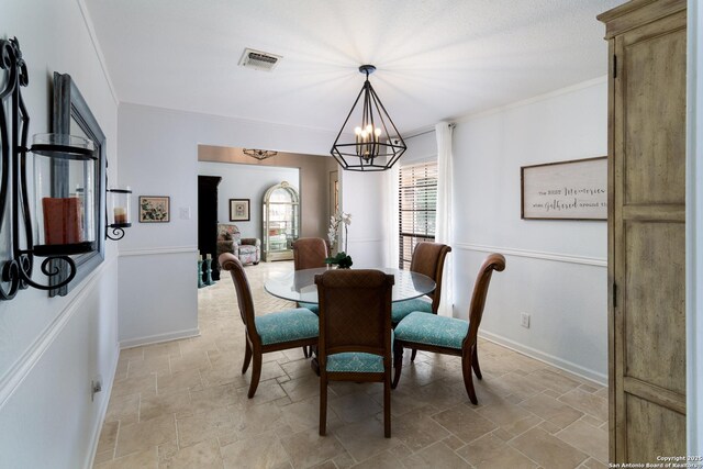 dining area featuring stone finish flooring, baseboards, a notable chandelier, and visible vents