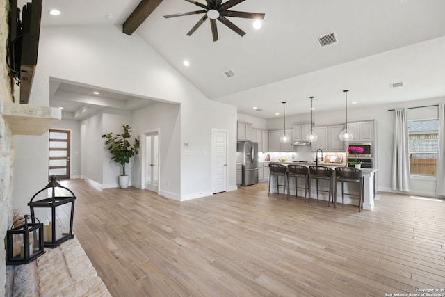 3818 Cualquiera, San Antonio, TX 78261 - living room featuring high vaulted ceiling, beamed ceiling, ceiling fan, baseboards, and light wood-style floors