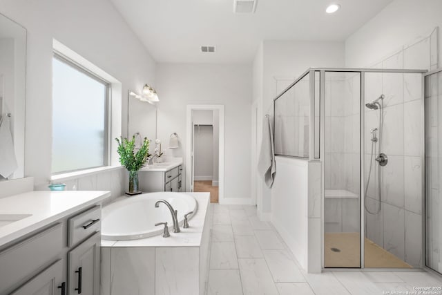 3818 Cualquiera, San Antonio, TX 78261 - bathroom with a stall shower, a bath, two vanities, marble look tiles, and a spacious closet