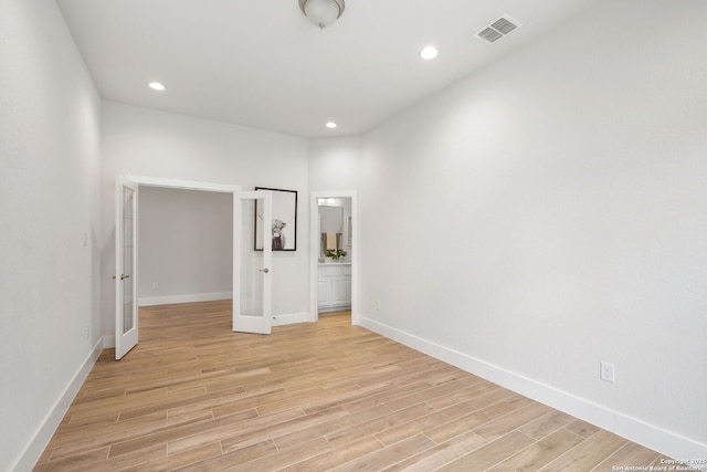 3818 Cualquiera, San Antonio, TX 78261 - spare room featuring light wood finished floors, baseboards, recessed lighting, and french doors